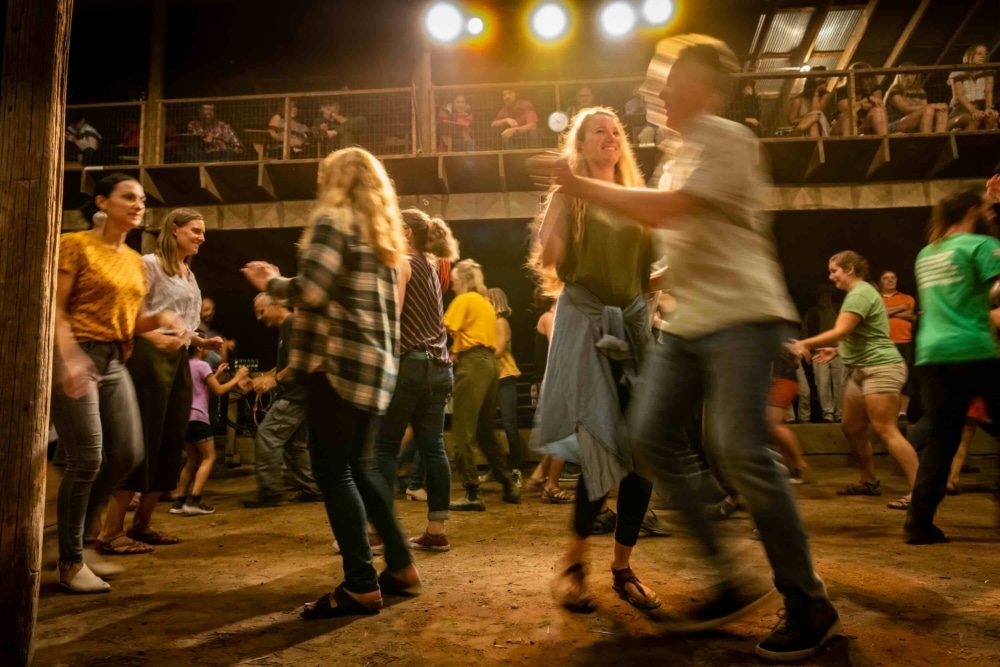 Dancers join the fun on the dirt floor of the Big Barn as the Land Institute Prairie Festival gets underway.