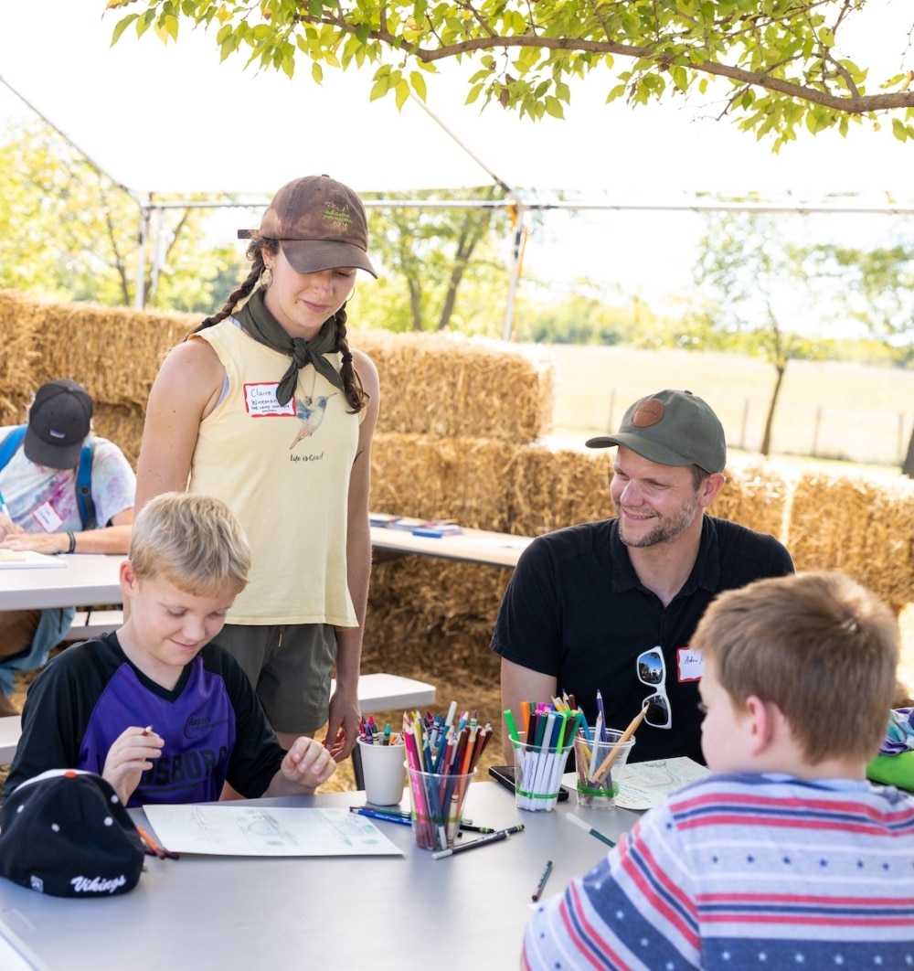 Two instructors teaching kids about Kernza